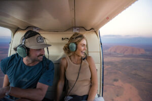 Couple (man and woman) on a scenic flight over Uluru