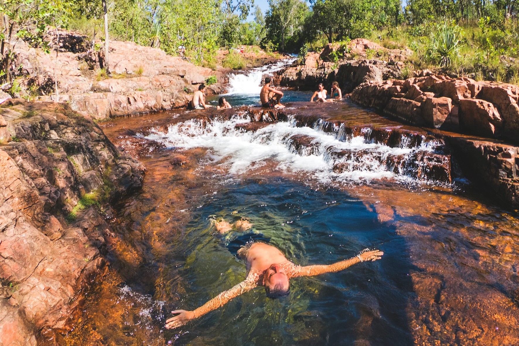 A visitor floating in the rock pool at Buley Rockhole