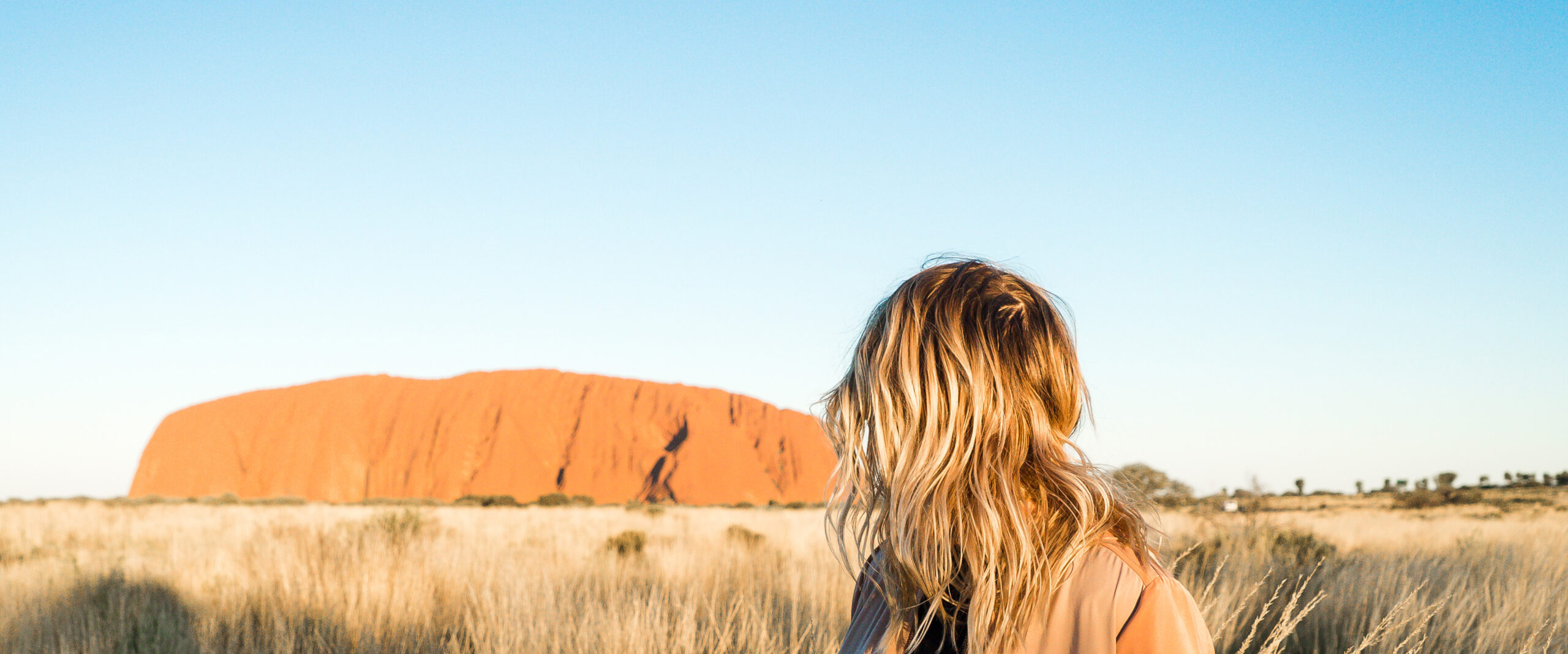 Girl Looking at Uluru in the distance